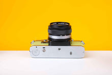 Load image into Gallery viewer, Olympus OM10 Slr Vintage 35mm Film Camera with Zuiko 50mm f1.8 Prime Lens Reconditioned With New Lime Leather Skin

