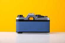 Load image into Gallery viewer, Olympus OM10 SLR Vintage 35mm Film Camera with Zuiko 50mm f/1.8 Prime Lens Reconditioned With New Blue Leather Skin
