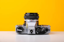 Load image into Gallery viewer, Olympus OM10 SLR Vintage 35mm Film Camera with Zuiko 50mm f/1.8 Prime Lens Reconditioned With New Blue Leather Skin
