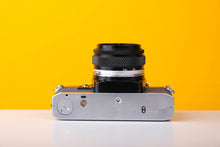 Load image into Gallery viewer, Olympus OM10 SLR Vintage 35mm Film Camera with Zuiko 50mm f/1.8 Prime Lens Reconditioned With New Blue Leather Skin
