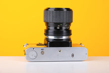 Load image into Gallery viewer, Olympus OM10 35mm SLR Film Camera in Yellow with Sigma 35-70mm f/2.8 Zoom Lens
