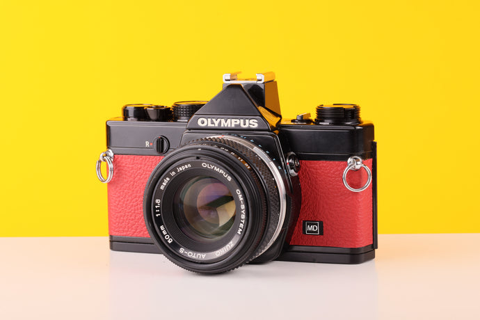 Olympus OM-1n 35mm SLR Film Camera with Zuiko 50mm f1.8 Lens red