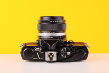 Load image into Gallery viewer, Olympus OM-2n MD Black 35mm Film Camera with Zuiko 50mm
