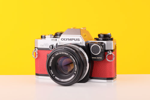 Olympus OM10 35mm Film Camera with Zuiko 50mm f1.8 Prime Lens Red Leather Skin and Manual Adapter