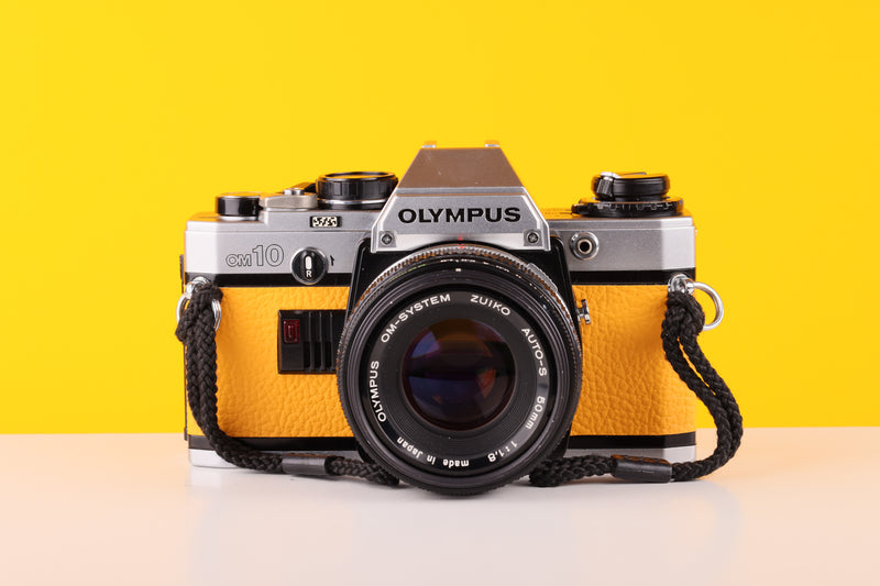 Olympus OM10 35mm SLR Film Camera with Olympus F.Zuiko Auto-S 50mm f1.8 Lens in Yellow