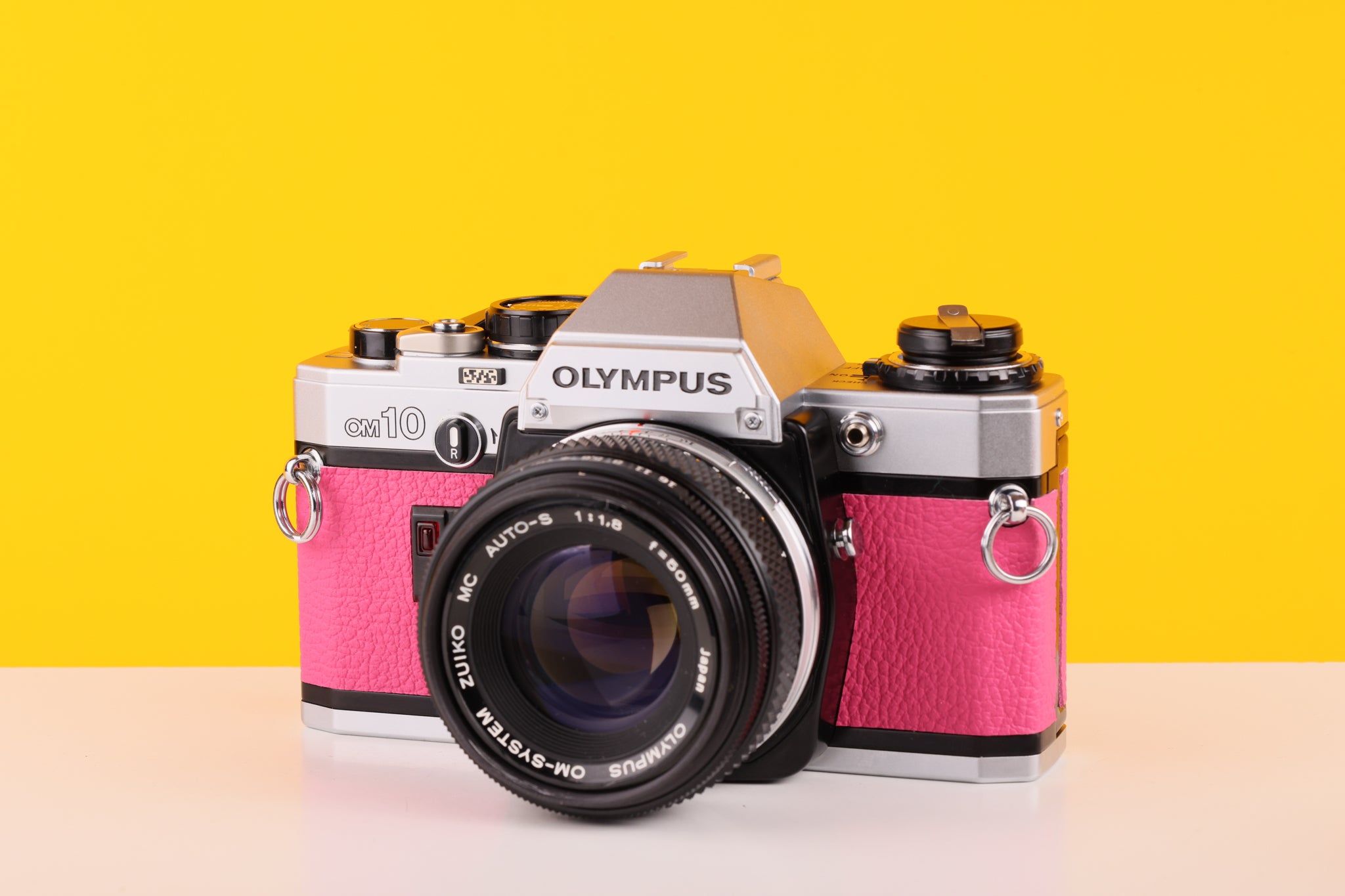
Olympus OM10 35mm SLR Film Camera with Olympus OM-System F.Zuiko Auto-S 50mm f1.8 Lens in Pink