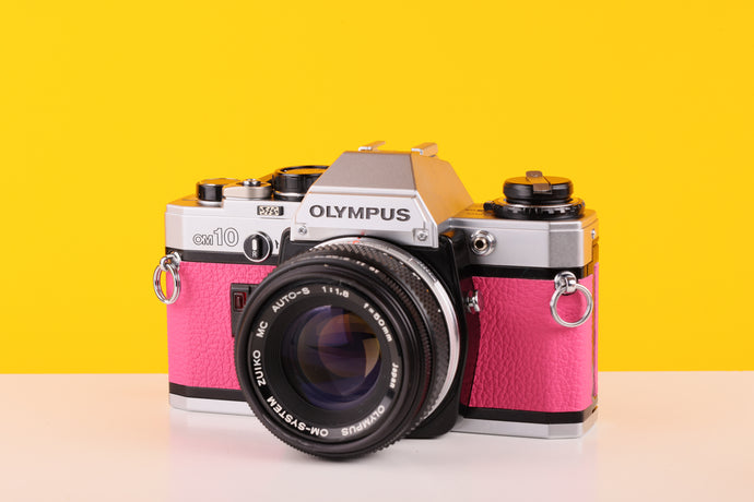 
Olympus OM10 35mm SLR Film Camera with Olympus OM-System F.Zuiko Auto-S 50mm f1.8 Lens in Pink