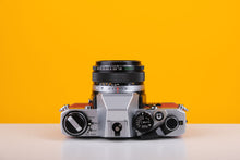 Load image into Gallery viewer, Olympus OM10 35mm Film Camera with Zuiko 50mm f1.8 Prime Lens Red Leather Skin
