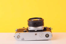 Load image into Gallery viewer, Nikon FE Silver 35mm Film Camera with Nikon 50mm f/1.8 Lens

