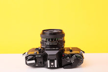 Load image into Gallery viewer, Canon AE-1 Black 35mm SLR Film Camera With 50mm F/1.8 Prime Lens
