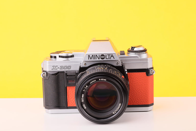 Minolta X-300 35mm Film Camera with Minolta MD 50mm f1.4 Lens in Orange