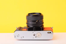Load image into Gallery viewer, Minolta X-300 35mm Film Camera with Minolta MD 50mm f1.4 Lens in Orange
