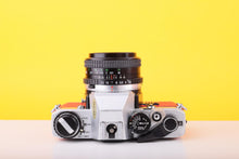 Load image into Gallery viewer, Olympus OM10 35mm SLR Film Camera with Miranda 28mm f/2.8 Lens in Scarlet Red
