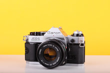 Load image into Gallery viewer, Canon AE-1 Program 35mm SLR Film Camera with Canon FD 50mm f/1.8 Lens – Boxed
