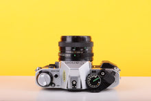 Load image into Gallery viewer, Canon AE-1 Program 35mm SLR Film Camera with Canon FD 50mm f/1.8 Lens – Boxed

