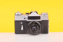 Load image into Gallery viewer, Zenit EM Silver 35mm Film Camera with Industar 50mm f/2 Lens
