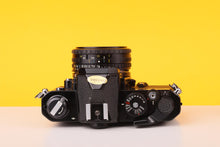 Load image into Gallery viewer, Nikon FM Black 35mm Film Camera with Nikon Nikkor 50mm f/1.8 Lens
