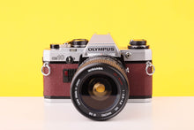 Load image into Gallery viewer, Olympus OM10 35mm SLR Film Camera with Miranda 28-70mm f3.5-4.5 MC Macro Lens Burgundy
