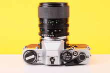 Load image into Gallery viewer, Olympus OM10 35mm SLR Film Camera with Miranda 28-70mm f3.5-4.5 MC Macro Lens Burgundy
