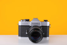 Load image into Gallery viewer, Yashica TL Electro 35mm SLR Film Camera with a Carl Zeiss MC 135mm f3.5 Lens
