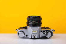 Load image into Gallery viewer, Canon AE-1 35mm SLR Film Camera with 50mm f1.8 lens
