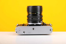 Load image into Gallery viewer, Canon AE-1 35mm SLR Film Camera with Canon Zoom FD 35-70mm f3.5-4.5 Lens
