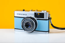 Load image into Gallery viewer, Vintage Olympus camera on a yellow background

