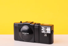 Load image into Gallery viewer, Vintage Olympus camera on a yellow background

