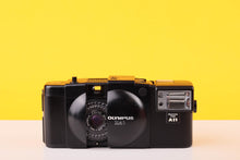 Load image into Gallery viewer, Vintage Olympus XA1 camera on a yellow background
