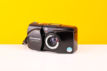 Load image into Gallery viewer, Olympus Mju Zoom 115 35mm Point and Shoot Film Camera with a zoom lens and built-in flash, displayed on a yellow and white background.
