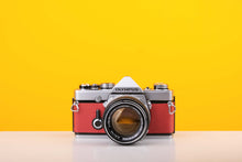 Load image into Gallery viewer, Olympus OM-1 35mm Film Camera with Olympus 50mm f/1.4 Prime Lens in Red
