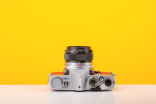 Load image into Gallery viewer, Olympus OM-1 35mm Film Camera with Olympus 50mm f/1.4 Prime Lens in Red
