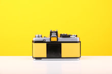 Load image into Gallery viewer, Olympus OM-2 35mm SLR Film Camera with Zuiko Olymplus OM-System G.Zuiko Auto-S 50mm f1.4 Lens in Yellow
