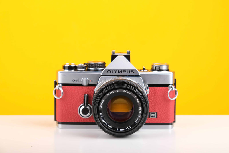 Olympus OM-2n MD 35mm SLR Film Camera with Zuiko Olympus OM-System Auto-S 50mm f1.8 Lens in Red
