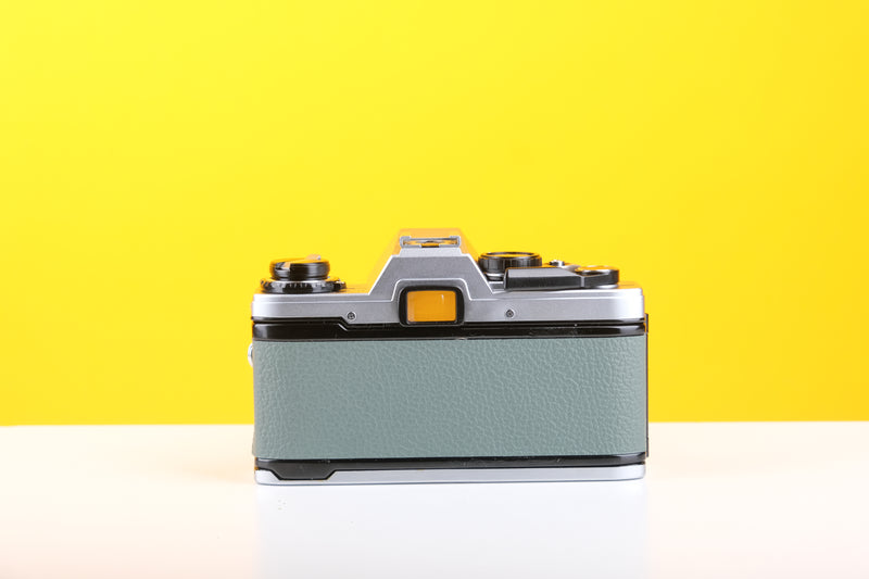 Olympus OM10 35mm Film Camera with Olympus Zuiko Auto-S 50mm f1.8 Lens in Safari Green