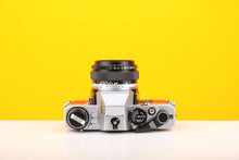 Load image into Gallery viewer, Olympus OM10 Slr Vintage 35mm Film Camera with Zuiko 50mm f1.8 Prime Lens with New Leather Red and Yellow Skin
