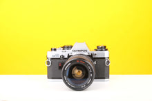 Load image into Gallery viewer, Olympus OM10 35mm SLR Film Camera with Miranda 28-70mm f3.8-4.8 MC Macro Lens
