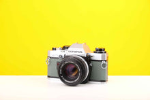 Load image into Gallery viewer, Olympus OM10 35mm Film Camera with Olympus Zukio Auto-S 50mm f1.8 Lens in Turquoise
