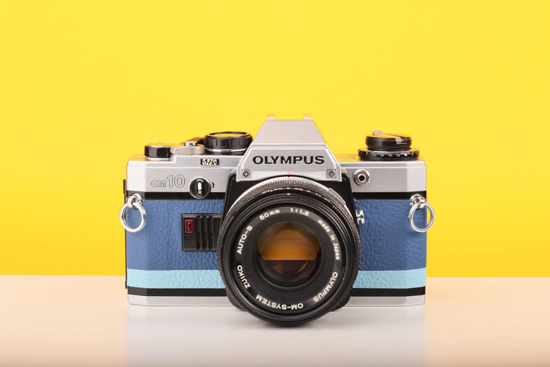 Olympus OM10 SLR Vintage 35mm Film Camera with Zuiko 50mm f/1.8 Prime Lens Reconditioned With New Blue Leather Skin