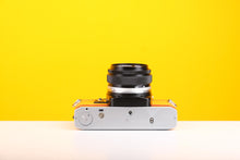 Load image into Gallery viewer, Olympus OM10 Slr Vintage 35mm Film Camera with Zuiko 50mm f1.8 Prime Lens and with New Leather Yellow and Red Skin
