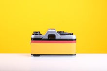 Load image into Gallery viewer, Olympus OM10 Slr Vintage 35mm Film Camera with Zuiko 50mm f1.8 Prime Lens and with New Leather Yellow and Red Skin
