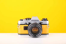 Load image into Gallery viewer, Olympus OM10 35mm SLR Film Camera with Manual Adapter and Olympus F.Zuiko Auto-S 50mm f1.8 Lens in Yellow
