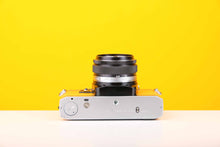 Load image into Gallery viewer, Olympus OM10 35mm SLR Film Camera with Manual Adapter and Olympus F.Zuiko Auto-S 50mm f1.8 Lens in Yellow

