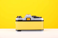 Load image into Gallery viewer, Olympus OM10 35mm SLR Film Camera with Manual Adapter and Olympus F.Zuiko Auto-S 50mm f1.8 Lens in Yellow
