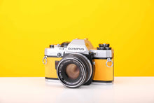 Load image into Gallery viewer, Olympus OM10 35mm SLR Film Camera with Manual Adapter and Olympus F.Zuiko Auto-S 50mm f1.8 Lens in Yellow
