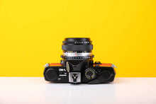 Load image into Gallery viewer, Olympus OM-1n 35mm SLR Film Camera with Zuiko 50mm f1.8 Lens in Red
