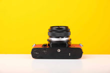 Load image into Gallery viewer, Olympus OM-1n 35mm SLR Film Camera with Zuiko 50mm f1.8 Lens in Red
