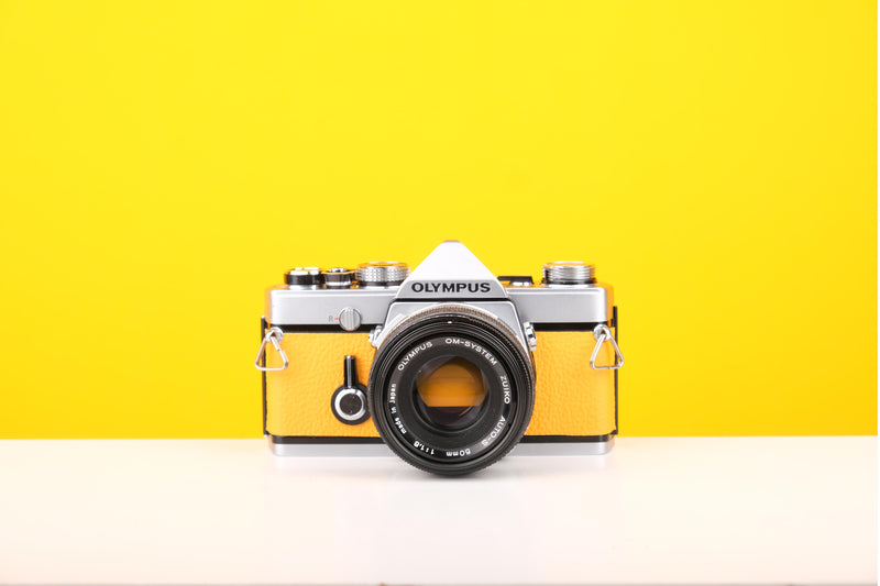 Olympus OM-1 35mm SLR Film Camera with Olympus OM-System Zuiko Auto-S 50mm f1.8 Lens in Yellow