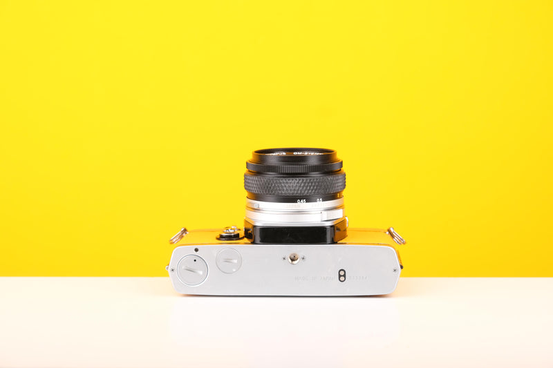 Olympus OM-1 35mm SLR Film Camera with Olympus OM-System Zuiko Auto-S 50mm f1.8 Lens in Yellow