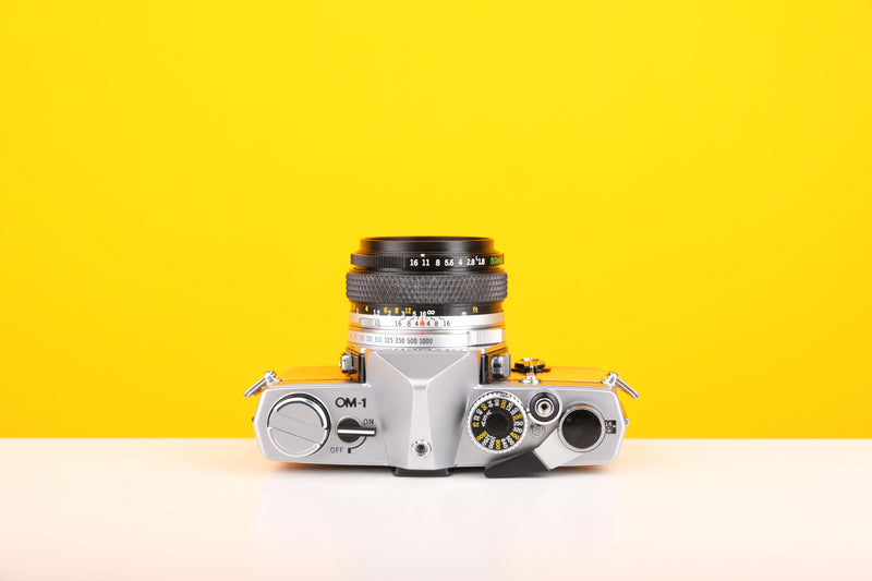 Olympus OM-1 35mm SLR Film Camera with Olympus OM-System Zuiko Auto-S 50mm f1.8 Lens in Yellow